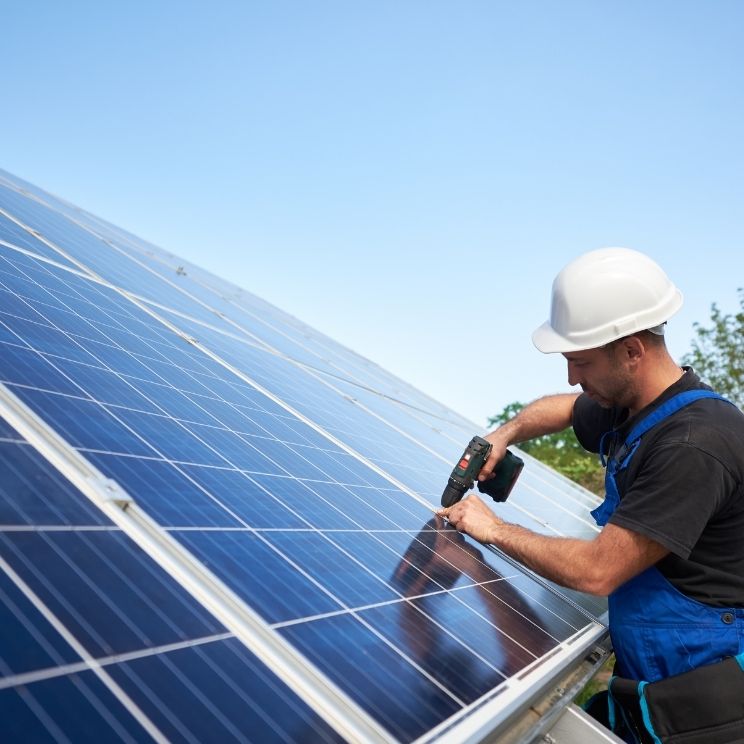 Electrical contractor installing solar panels.